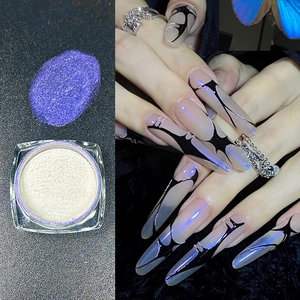 Macro shot of purple chameleon nail powder with iridescent aurora effect on long nails