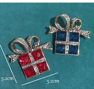 Detail of red and blue gift box brooches with rhinestones and 5.2cm size measurement