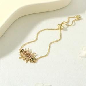 Detailed view of adjustable gold-plated bracelet with rainbow zircon starburst pendant