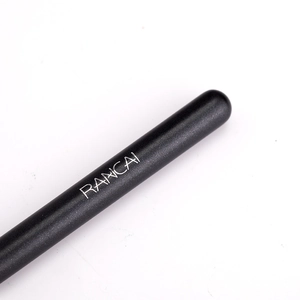 Detailed macro view of the matte black handle with silver RANCAI brand logo on foundation brush