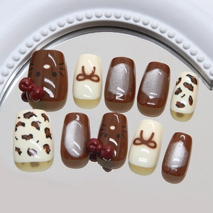Cat-eye press-on nails with cartoon bow and leopard pattern in warm brown autumn style