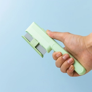 Self-cleaning pet brush with fine metal bristles and light green ergonomic handle
