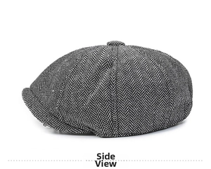 Side view detail of grey herringbone newsboy cap showing fabric texture and stitches