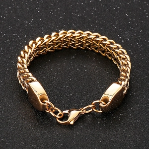 Close-up of golden double-row wheat chain bracelet with a secure lobster clasp