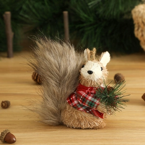 Handcrafted straw squirrel Christmas ornament with red plaid scarf on wooden table