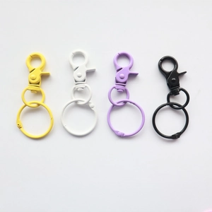 Colorful metal lobster clasp keychains with snap rings in yellow, white, purple, and black