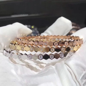 Three honeycomb bangles in rose gold, gold and silver finishes with pavé diamonds
