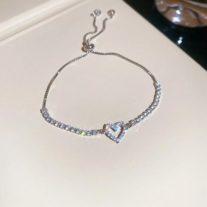 Detailed view of silver heart-shaped zircon bracelet with adjustable slider closure