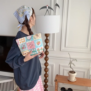 Detail of quilted cotton makeup bag with cute floral patterns and zip closure