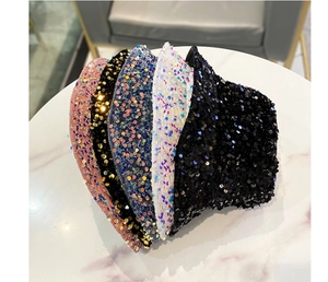 Stacked view of shimmering sequin bucket hats in pink, gold, blue, white, and black colors