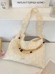 Creamy white jacquard shoulder bag with 3D floral textures and amber beaded handle