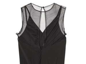 Detail of elegant black dress featuring sheer mesh back insert and invisible zipper closure