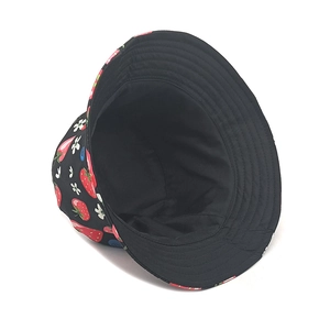 Close-up of strawberry print fabric and durable cotton lining on reversible bucket hat
