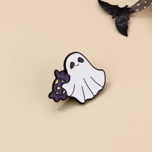 Detailed view of Halloween ghost enamel pin holding a purple candy with bat accents