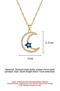 Detail view of star and moon pendant with dimensions 2.3cm by 2cm on gold chain
