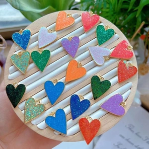Detailed view of colorful glitter heart pendants for DIY jewelry making accessories