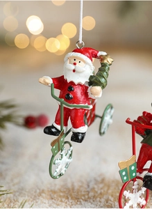 Close-up of Santa Claus on a bicycle ornament with vibrant red and green festive details