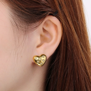 Polished 18K gold plated heart hoop earrings with zircon star accents on female ear