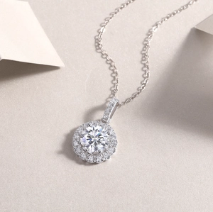 Macro shot of silver S925 halo pendant with 2ct moissanite stone and pave details