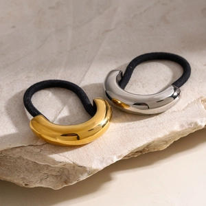Detail of high-elasticity hair ties with polished gold and silver U-shaped metal accents