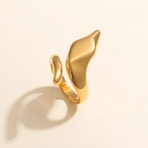 Detailed close-up of 18K gold plated snake-shaped wrap ring on minimalist beige surface