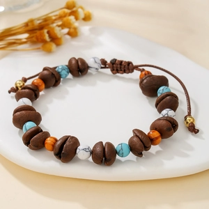 Detail of coffee bean wood beads and stone beads on a woven bohemian charm bracelet