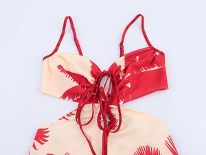 Detail of red palm leaf print dress featuring slim straps and hollow-out lace-up design