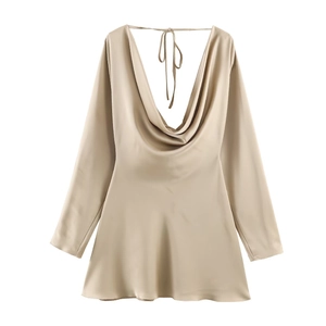 Detailed view of champagne satin dress featuring a draped cowl neck and silky texture