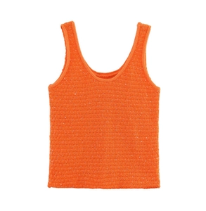 Close-up of bright orange sleeveless knit sweater top featuring detailed ribbed texture
