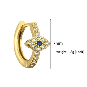 Golden huggie hoop earrings with colorful cubic zirconia and evil eye charm