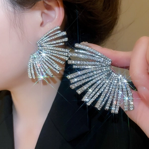 Detail of silver fan-shaped earrings with sparkling pavé crystals for elegant women