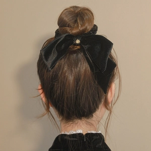 Elegant large black velvet bow scrunchie with metal charm for women's hairstyle