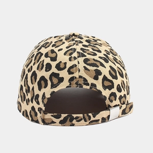 Detail view of the cow print baseball cap featuring an adjustable metal buckle back closure