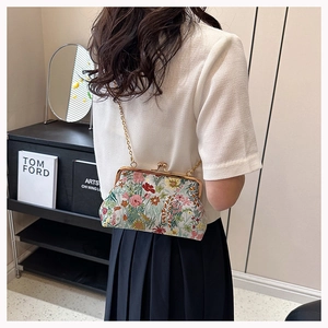 Detailed embroidery on vintage floral jacquard bag with gold metal clasp and chain