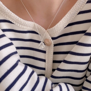 Close-up of a 925 sterling silver necklace with irregular lava texture on a model