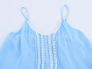 Close-up of light blue chiffon strap dress featuring white lace trim and pleated details