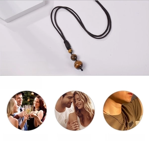 Detailed view of natural tiger eye stone pendant with adjustable black braided cord