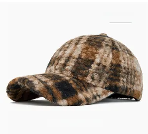 Close-up of khaki plaid wool baseball cap showing thick plush texture and winter fabric