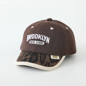 Detail of Brooklyn embroidery on brown knit baseball cap with leopard print brim