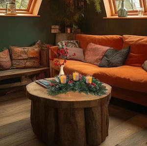 Christmas candle holder with holly berries, pine needles and three glass cups on wood table
