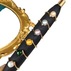 Set of six minimalist freshwater pearl rings in assorted colors with golden bands