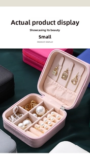 Pink portable jewelry box interior with necklace hooks, ring slots, and velvet lining