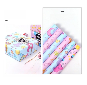Detail of cartoon baby shower wrapping paper featuring cute ducks and moon patterns
