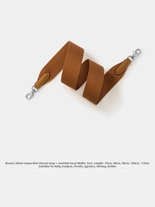 Close-up of brown wax thread woven shoulder strap with cowhide head and silver metal clasps