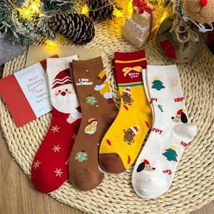 Set of four Christmas themed crew socks in red, brown, and beige with festive decor