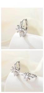 Macro detail of S925 silver starburst earrings featuring sparkling round cubic zirconia