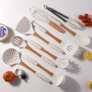 8-piece white silicone cooking utensil set with wooden handles on a white background