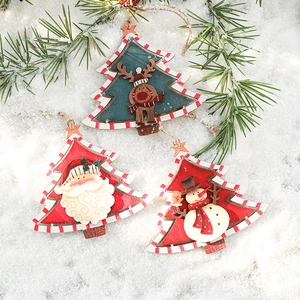 Three vintage Nordic wooden Christmas tree ornaments with painted Santa, snowman and reindeer