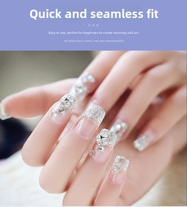 Detail of transparent press-on nails with silver glitter and white rhinestones