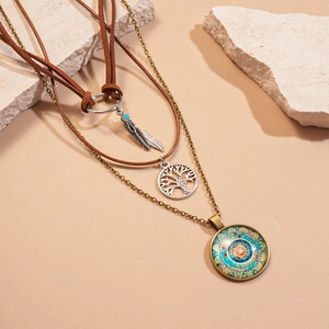 Three-layer bohemian necklace featuring leaf and mandala pendants with turquoise accents